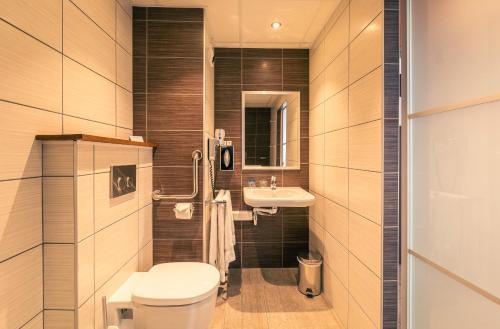 a bathroom with a toilet and a sink at Best Western Marseille Aeroport in Vitrolles