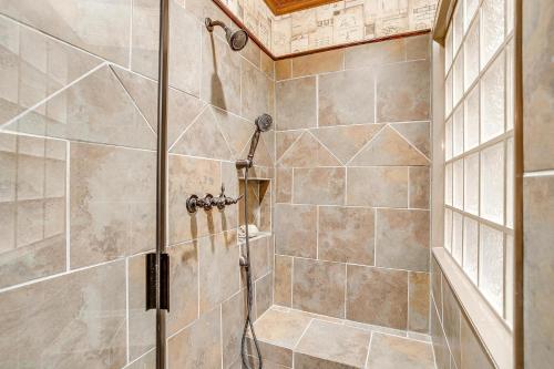 a shower with a glass door in a bathroom at The Gallery House Boutique Hotel in Stephenville