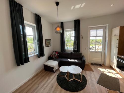 a living room with a couch and a table at Leevke in Lastrup