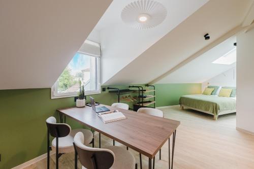 a room with a table and chairs and a bed at Appart Hotel Neostelia in Annecy