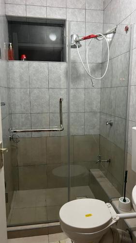 a bathroom with a glass shower with a toilet at FlexHomes-Ongata Rongai in Ongata Rongai 