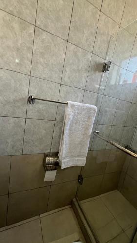 a shower with a white towel on a glass door at FlexHomes-Ongata Rongai in Ongata Rongai 