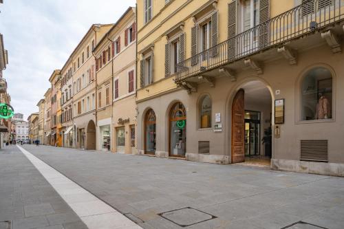 an empty street in a city with buildings at Gioia del Corso in Iesi