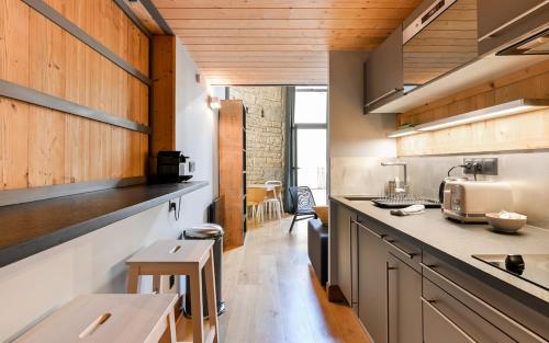 une cuisine avec des armoires en bois et un comptoir dans l'établissement Le petit Sully Foch, à Lyon