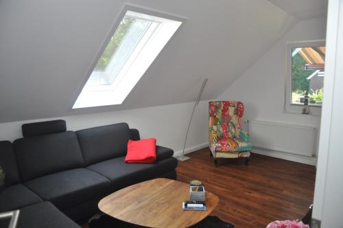 a living room with a couch and a table at Am Alten Leuchtfeuer in Eckernförde