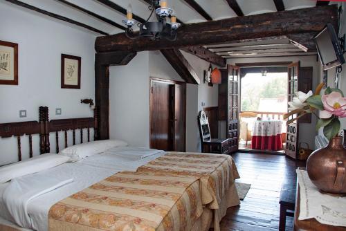 a bedroom with a large bed in a room at Posada Ansorena in Santillana del Mar