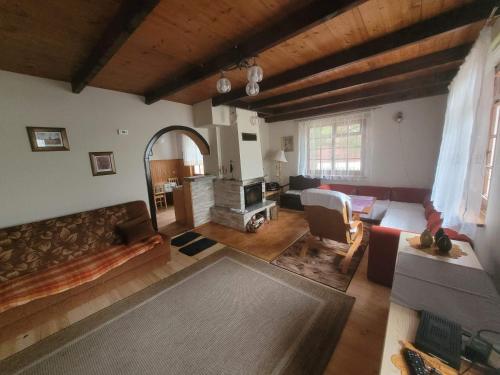a living room with a couch and a table at Domek Letniskowy - Jerutki in Jerutki