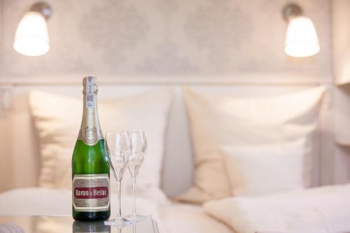 a bottle of champagne and two glasses on a table at Wy & Spa in Pobierowo