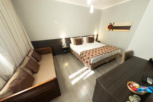 Postel nebo postele na pokoji v ubytování Class Hotel Guaxupé