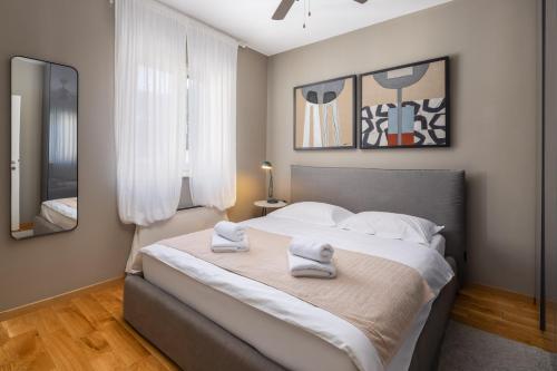 a bedroom with a large bed with towels on it at ZK luxury Villa in Murter
