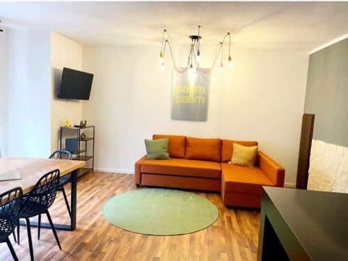 a living room with a couch and a table at EasyOne Apartments in Frankenthal