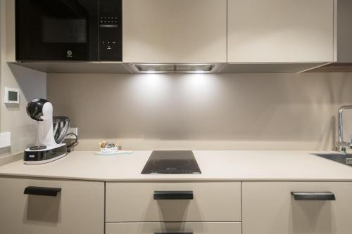 a kitchen with a white counter top with a blender at APARTAMENTS LA CARPA in Banyoles