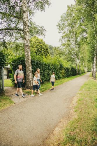 a group of people walking down a dirt road at Camping Bad Liebenzell in Bad Liebenzell