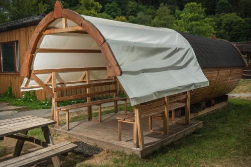 a wooden house with a cover on top of it at Camping Bad Liebenzell in Bad Liebenzell