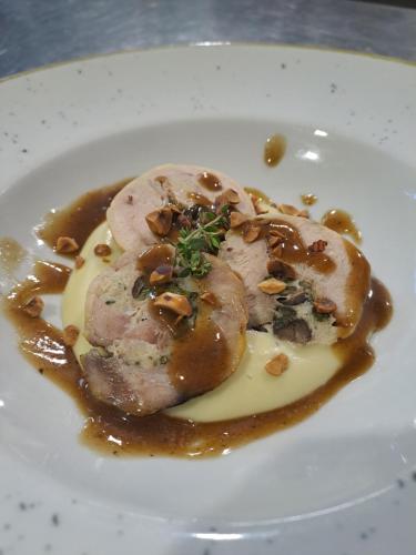 a plate of food with meat with sauce and nuts at Hotel Lo Smeraldo in Roccavivara