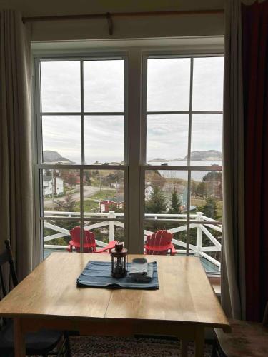 a table in front of a window with a view at The Crows Nest Studio in Trinity East in Port Rexton