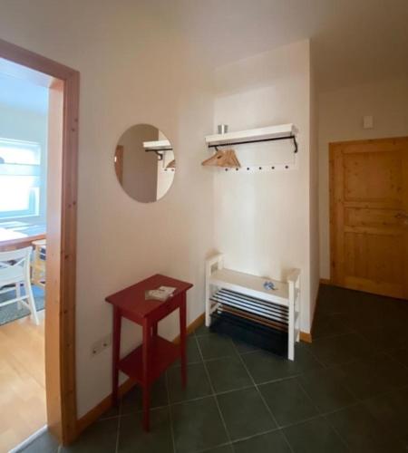 a room with a table and a mirror and a door at Rohrbruch in Lansen
