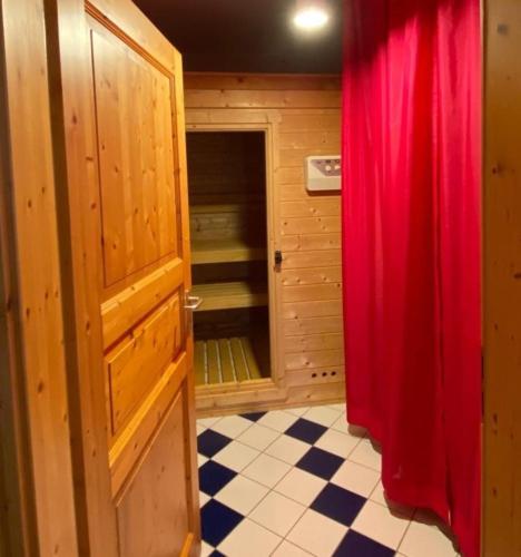 a room with a door and a red curtain at Rohrbruch in Lansen