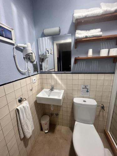 a bathroom with a toilet and a sink at Hostal La Lluna in Arenys de Mar