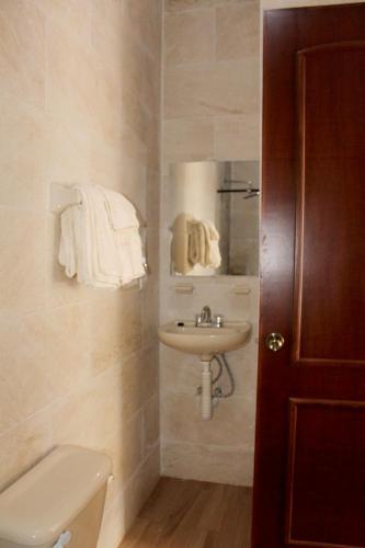 a bathroom with a sink and a toilet at Posada San Jorge in Cuetzalán del Progreso