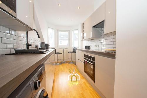 a kitchen with a counter with a light on the floor at Affleck Retreat 3 - SJA Stays - Modern 1 Bed Apartment in Aberdeen