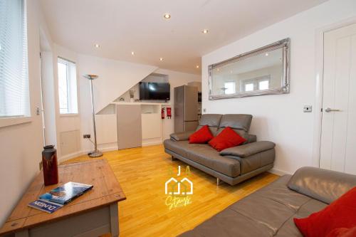 a living room with a couch and a table at Affleck Retreat 3 - SJA Stays - Modern 1 Bed Apartment in Aberdeen