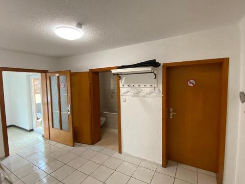 une chambre vide avec une porte et un réfrigérateur dans l'établissement Apartment und Ferienwohnung Mackenbach 2, à Mackenbach