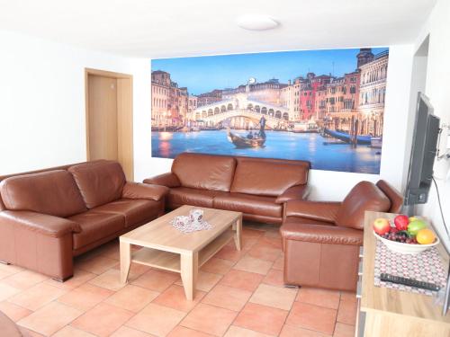 a living room with a couch and a painting of a canal at Wohnung "Venedig" in Heede