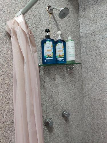 a shelf in a shower with two bottles of soap at Casa Cebra by the beach -Roof top lounge! Playa del Niño in Cancún