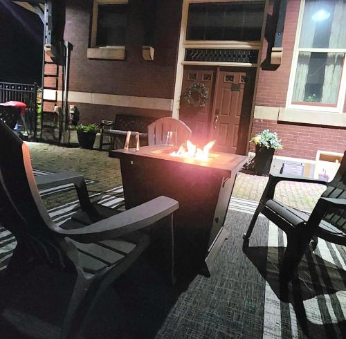 a bar with two chairs and a table with candles at Historic Springville Train Depot Inn Hotel Apartment in Springville