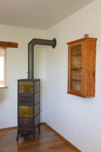 a wood stove in a room with a cabinet at Haus Oskar in Görwihl