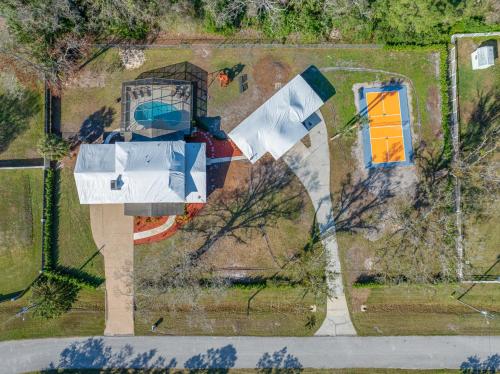 an aerial view of a house with a building at The Perfect Family Retreat w Pool and Games in West Chase