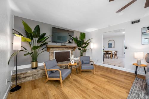 a living room with a fireplace and two chairs at The Perfect Family Retreat w Pool and Games in West Chase