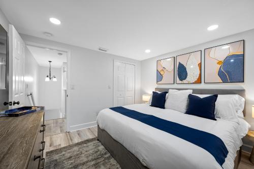 a bedroom with a large bed with blue and white pillows at The Perfect Family Retreat w Pool and Games in West Chase