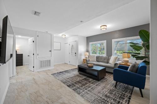 a living room with a couch and a table at The Perfect Family Retreat w Pool and Games in West Chase