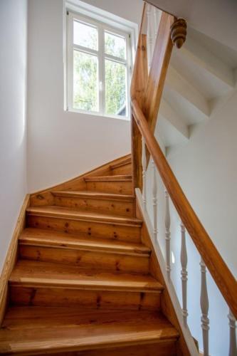 a wooden staircase with a window in a house at Apartment No6 in Stralsund