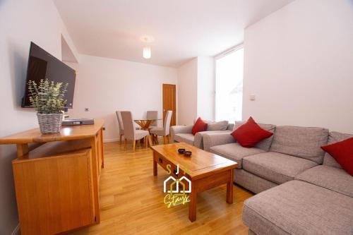 a living room with a couch and a table at Affleck Stay 2 - SJA Stays - Modern 2 Bed Apartment in Aberdeen