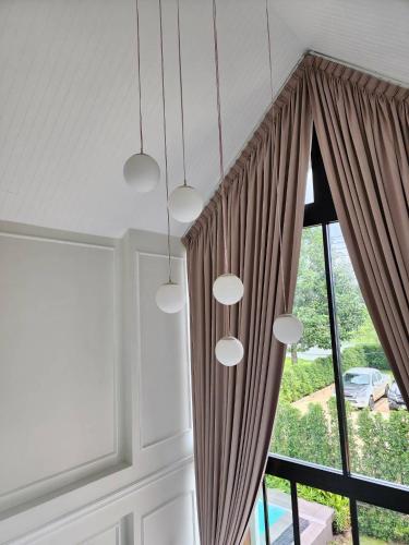 a room with a window with brown curtains at Colmar PoolVilla Khao Yai in Wangkata