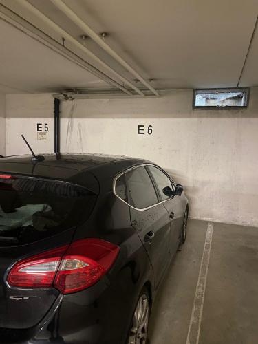 a black car parked in a parking garage at Appartement Raineck in Mittenwald