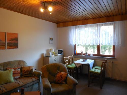 a living room with a couch and chairs and a table at Ferienhaus Köllner in Fischbach