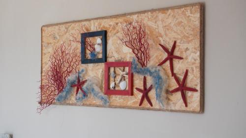 a picture on a wall with two pictures on it at Caletta sul Mare in La Caletta