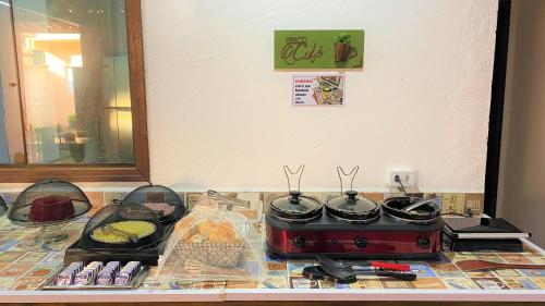 a counter top with a stove and pots and pans at Suíte Lázaro in Ubatuba