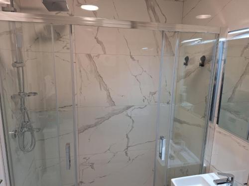 a bathroom with a shower and a sink at G-mol app in Buzin