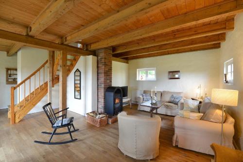 a living room with a couch and a fireplace at Ferienhaus Remise 6 Personen mit Terrasse in Neuenkirchen