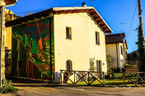 a building with a painting on the side of it at LA PAJARELLA di ZOER in Aielli