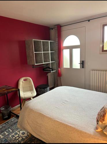 - une chambre avec des murs rouges, un lit et une fenêtre dans l'établissement Vivez la magie de Carnac au coeur des alignements, à Carnac