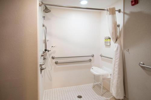 a bathroom with a toilet and a towel rack at King Bed Hotel Room 152 in Jackson