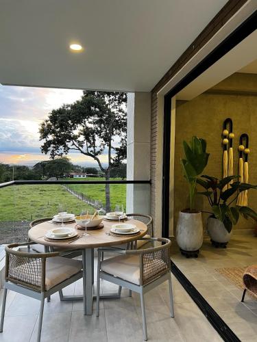 a dining room with a table and chairs at Tropicalia Home - Apartment in Armenia
