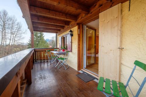 a room with a balcony with a table and chairs at Gästehaus Schlegel in Gunzesried
