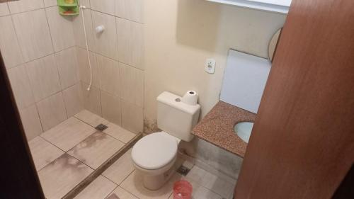 a small bathroom with a toilet and a shower at Alugo para Carnaval in Araruama